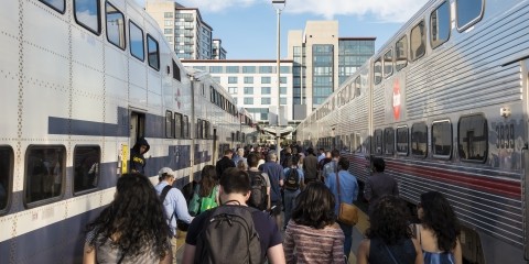 A crowd of passengers exit Caltrain at the San Francisco station.
