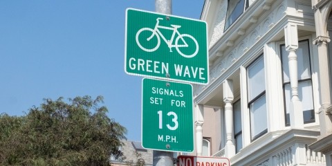 A green wave sign on Folsom Street