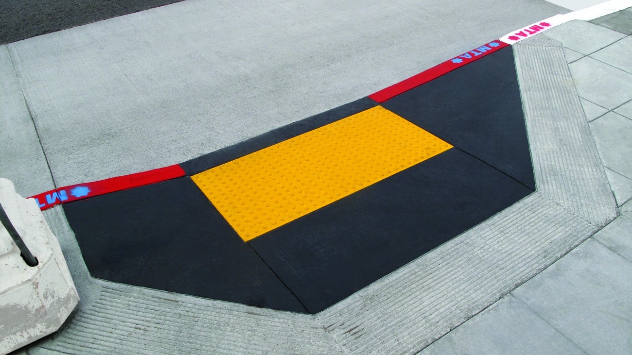 A bright yellow curb ramp