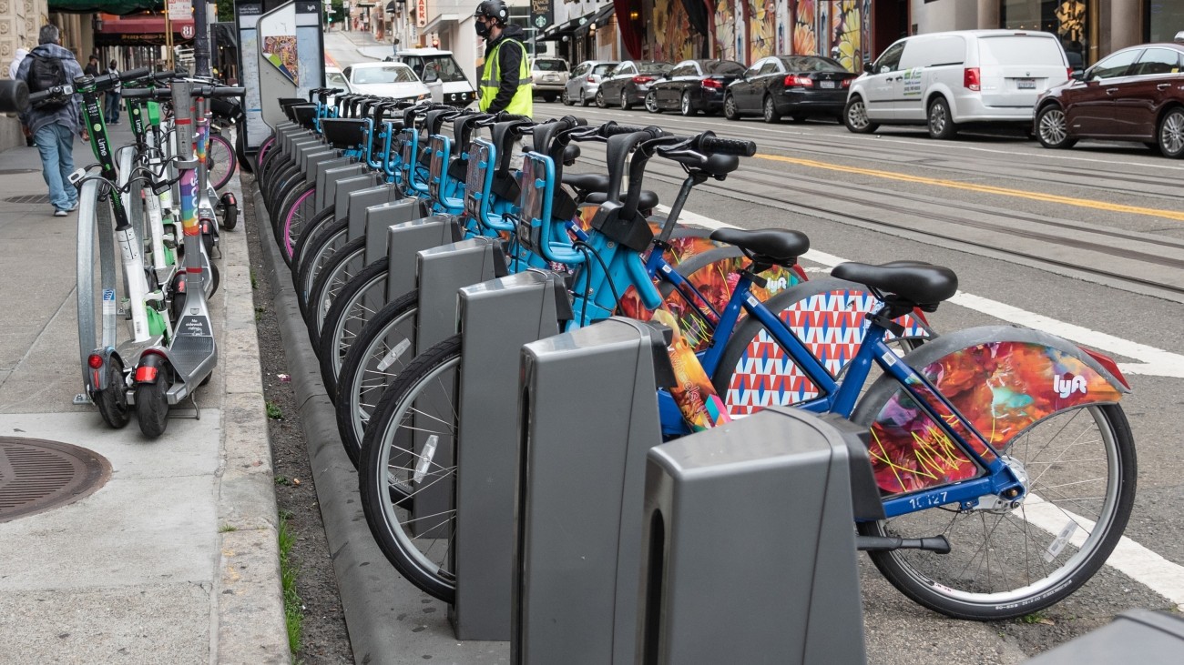 A bike share station filled with bikes.