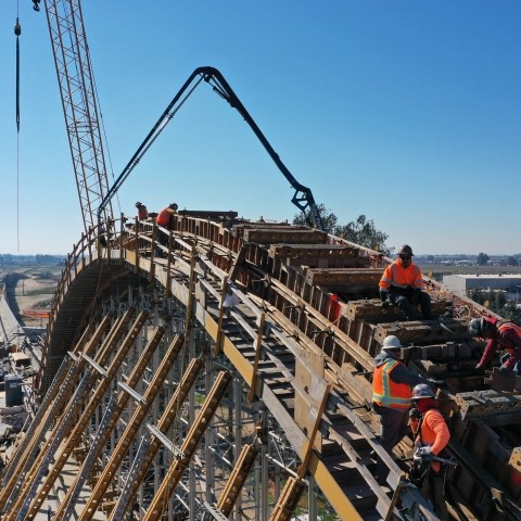 Workers constructing transportation infrastructure