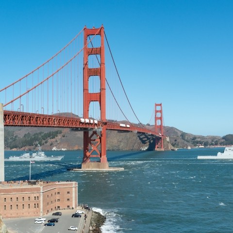 View of the red Golden Gate Bridge with blue skies and blue water