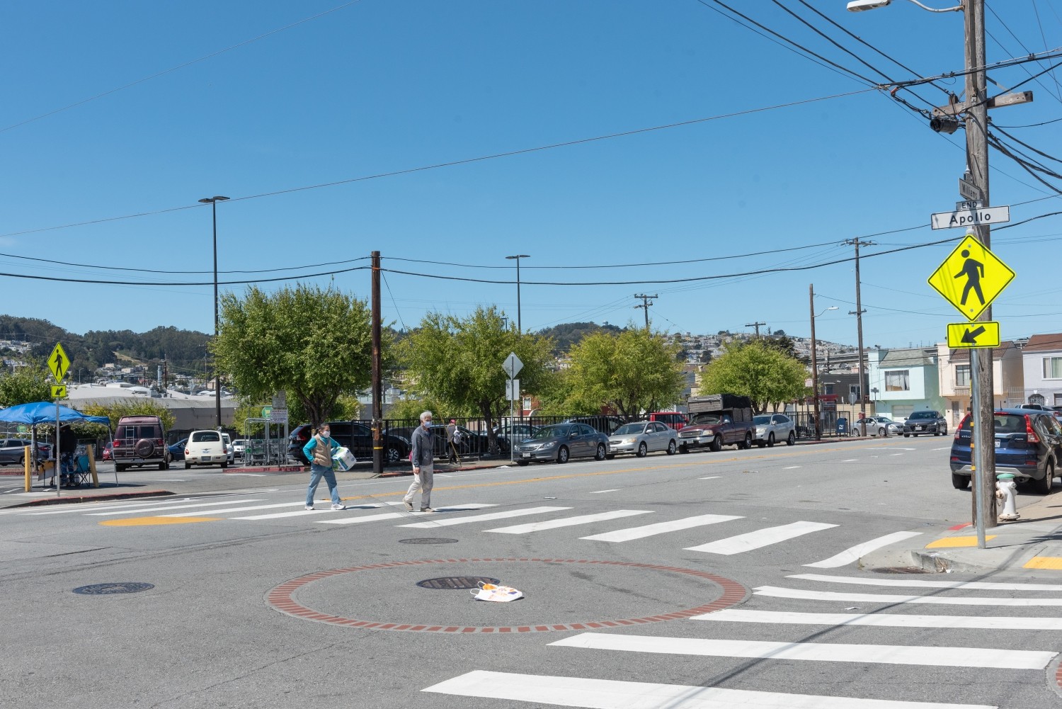 Intersection of Apollo and Williams in the Bayview District, pedestrians cross in crosswalk 