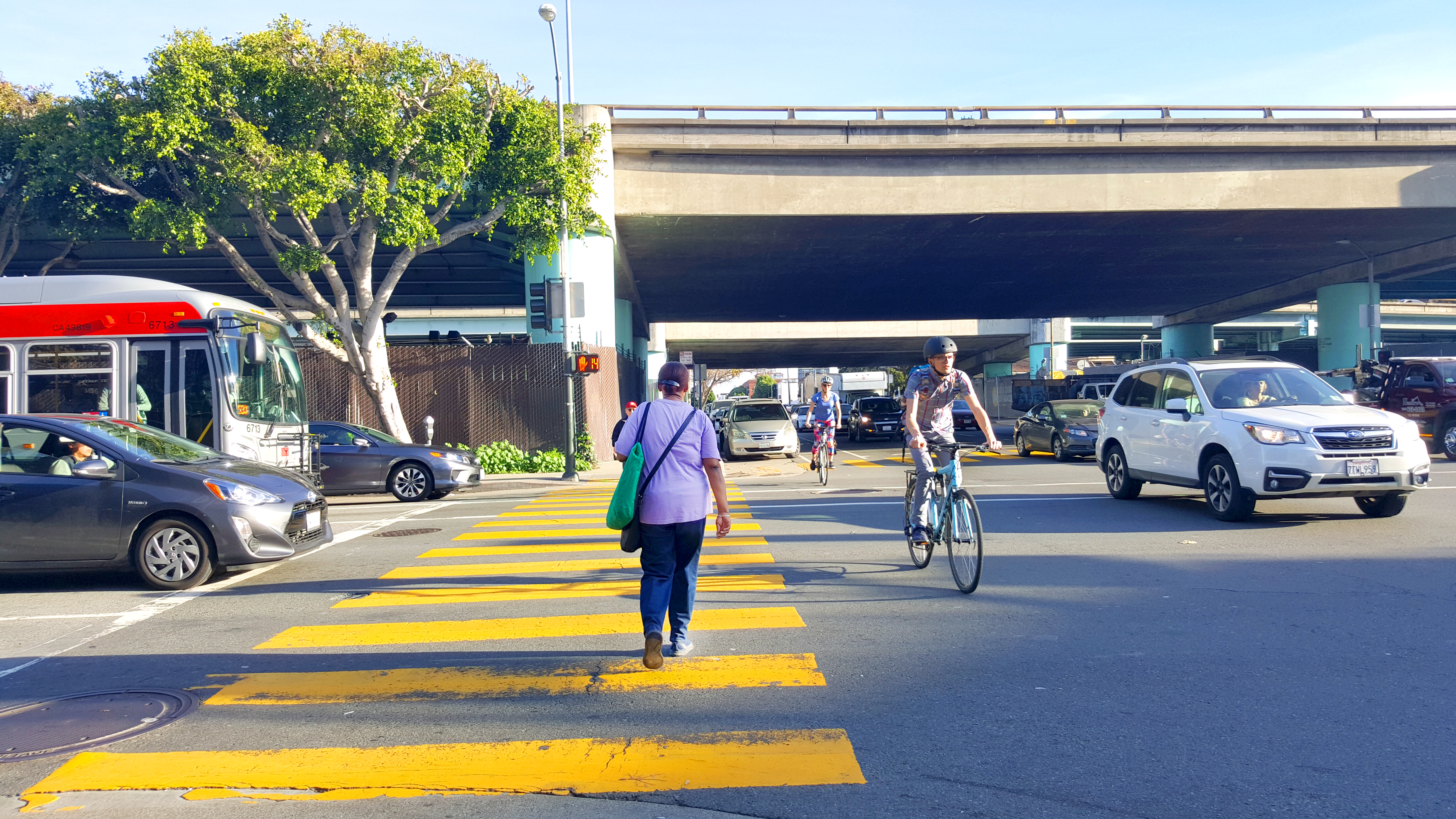 An image of cars, bicyclists, pedestrians, and buses at Harrison & 7th streets