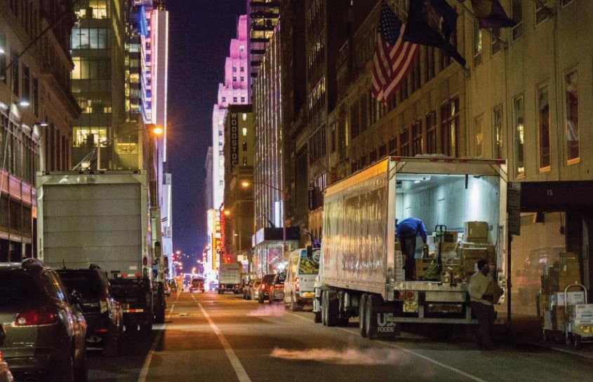 A truck unloading during the nighttime when there is plenty of space