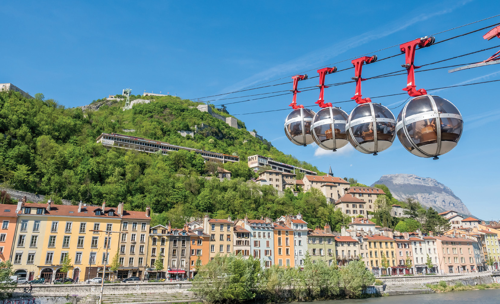 The Grenoble Bastille gondola system, showing cabins traveling between the city center of Grenoble and the Fort de la Bastille.