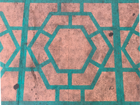 A close up of a geometric pattern in teal stone against a pink background.