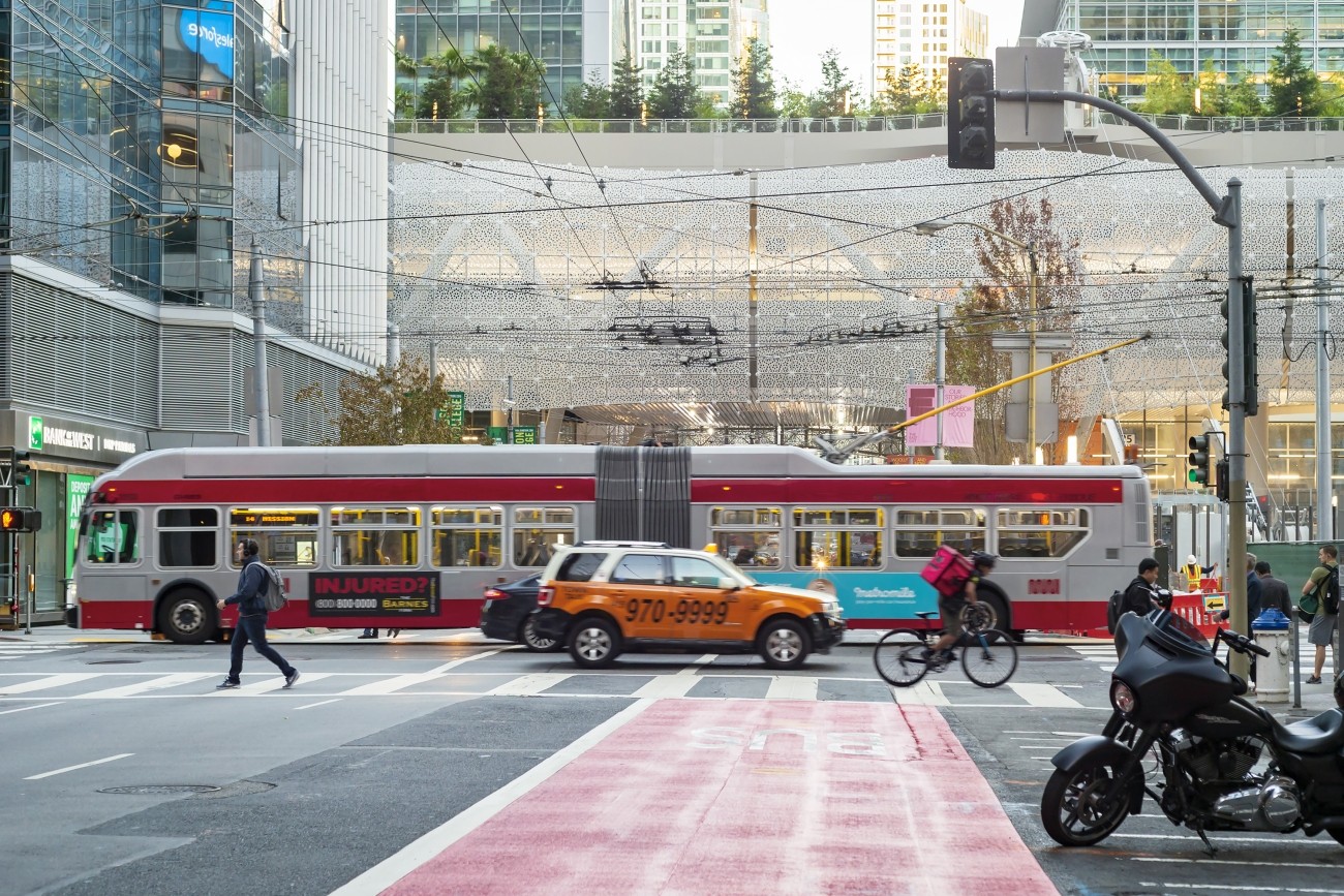 A view of the Salesforce Transit Center, a red transit-only lane, and a bus