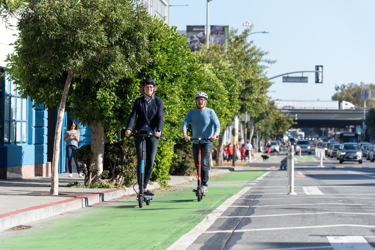 People on scooters in a bike lane