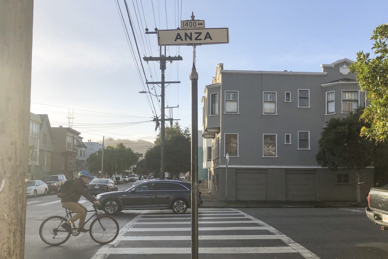 A bicyclist riding on Anza Street