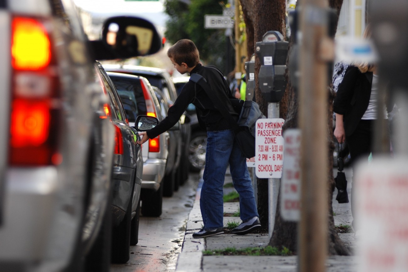 Photo of student getting into parent's car at school