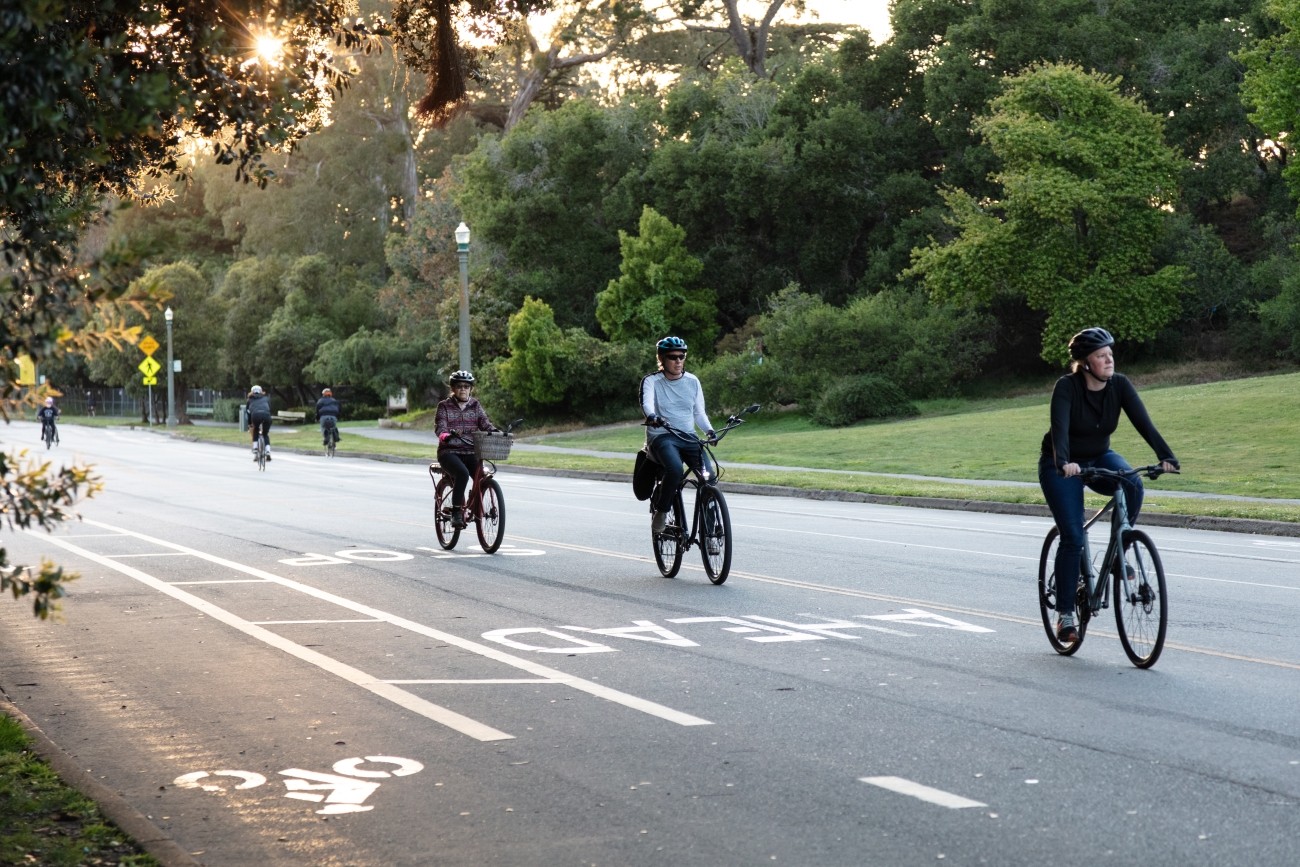 People biking on a street in Golden Gate Park.