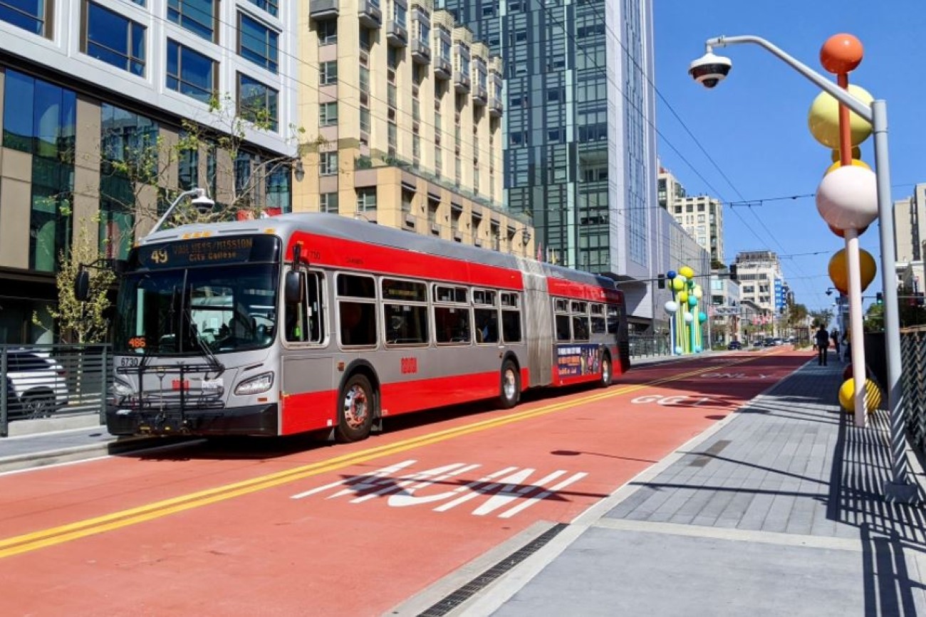Photo of Van Ness bus in bus-only lane at a station