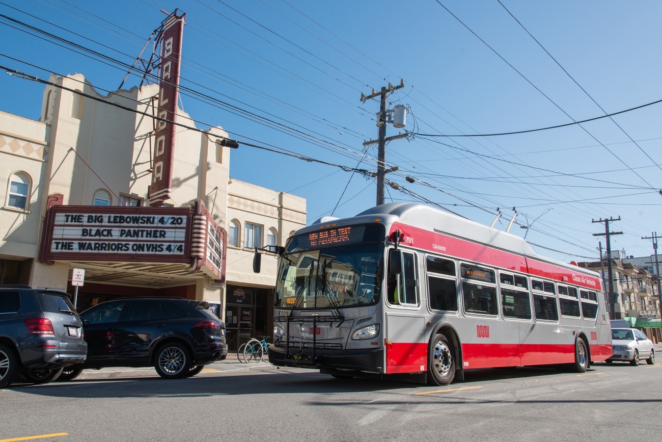 A Muni bus drives by the Balboa Theater located in District 1 in San Francisco. 