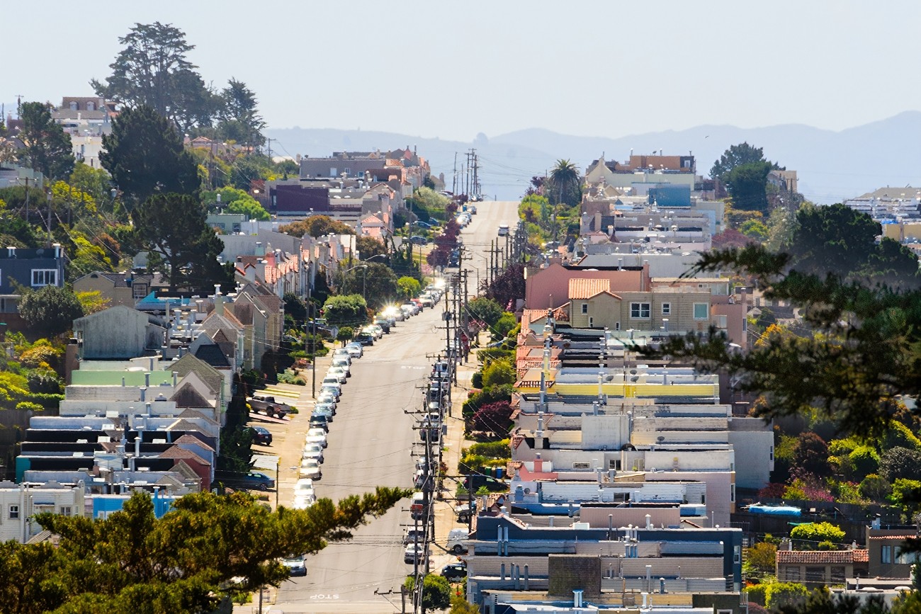 A view of a hilly street in the Inner Sunset, seen zoomed-in from a distance