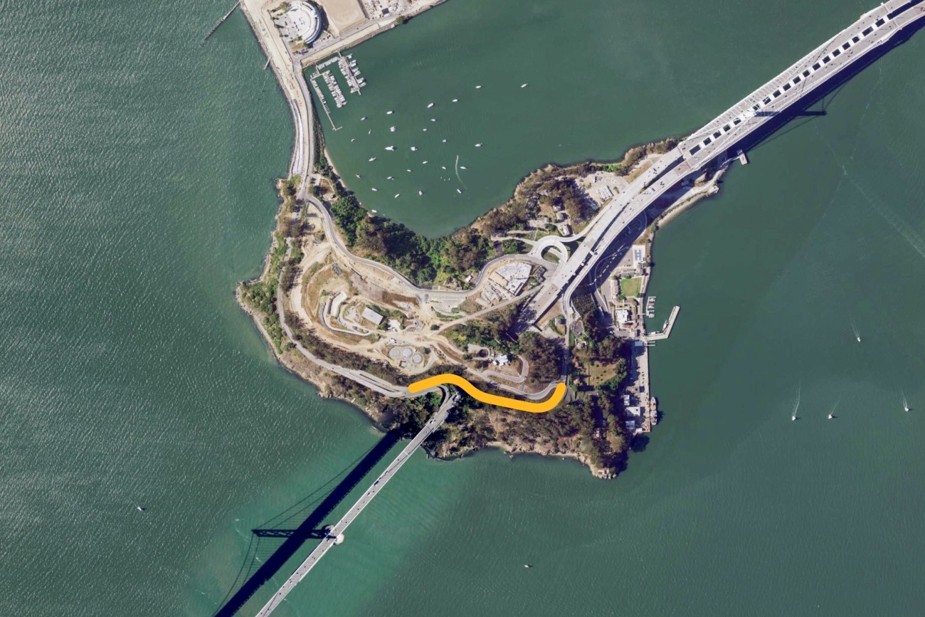 A satellite photo of Yerba Buena Island with north pointing up. The Hillcrest Road project area, which runs along Hillcrest Road from the westbound bridge on-ramp to Forest Road, is highlighted in yellow.