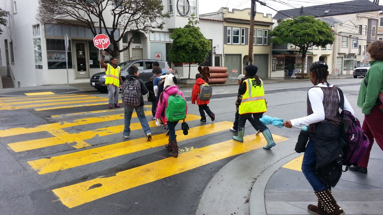 Kids crossing the street with a crossing guard at 20th and Connecticut streets