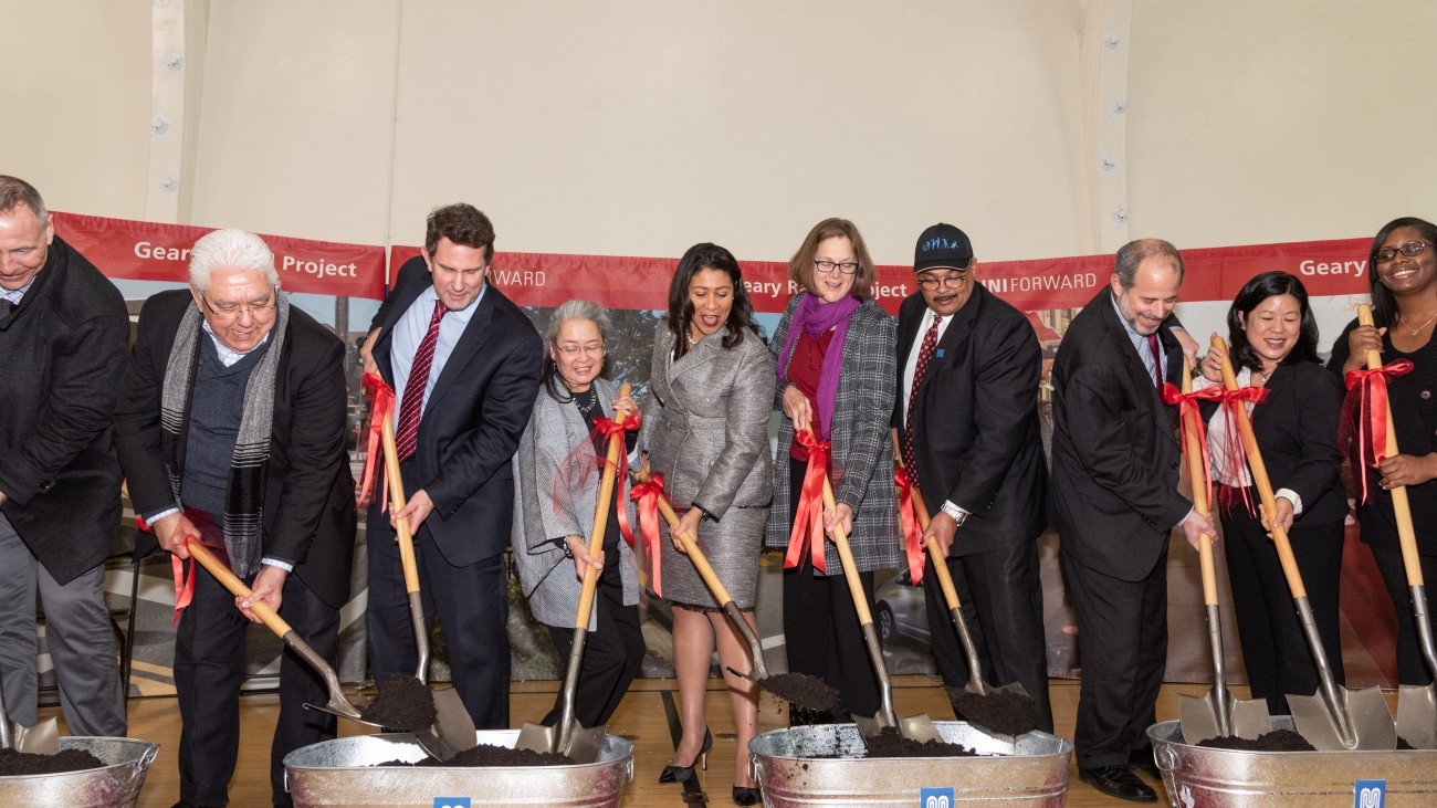 Elected officials digging shovels into dirt at the Geary groundbreaking