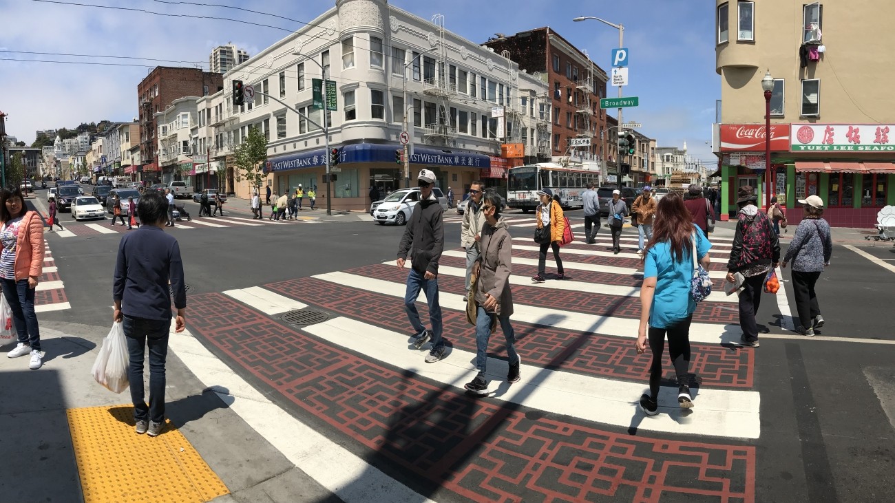 People crossing the street in a new crosswalk in Chinatown 
