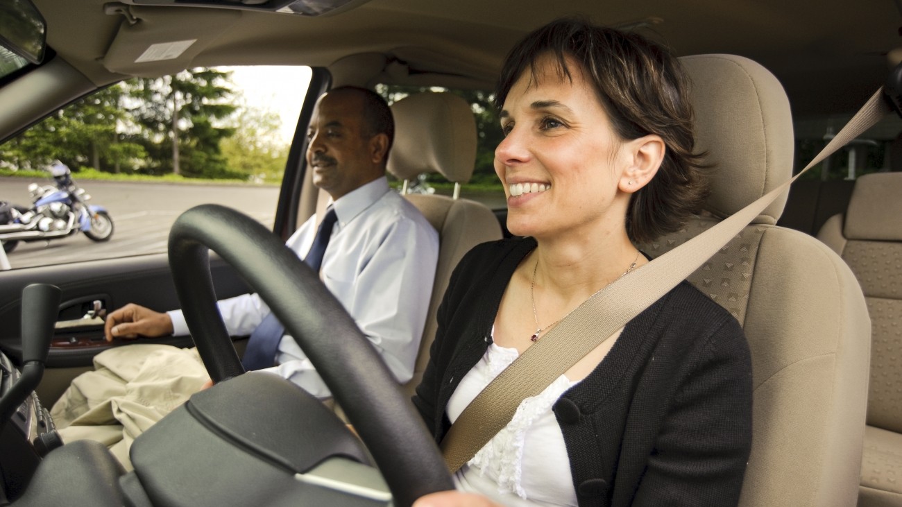 A woman driving a vanpool