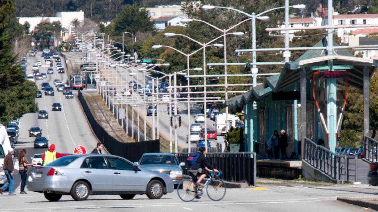 People cross 19th Avenue at Holloway