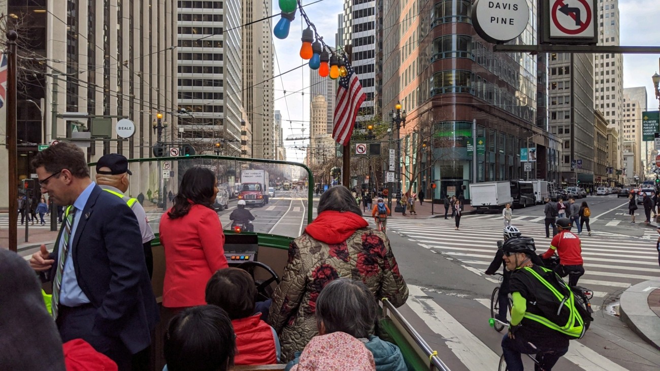 People riding the boat tram on car-free market street