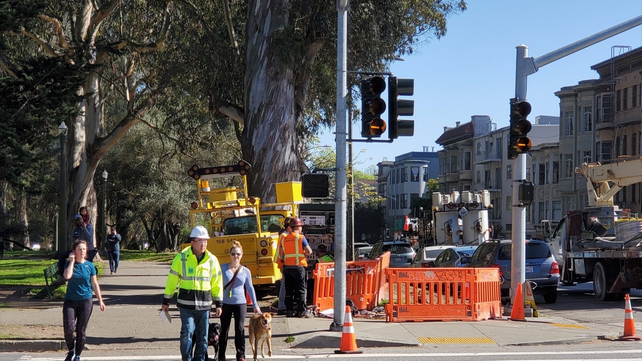 Pedestrians walking on a cross walk using the new traffic signals