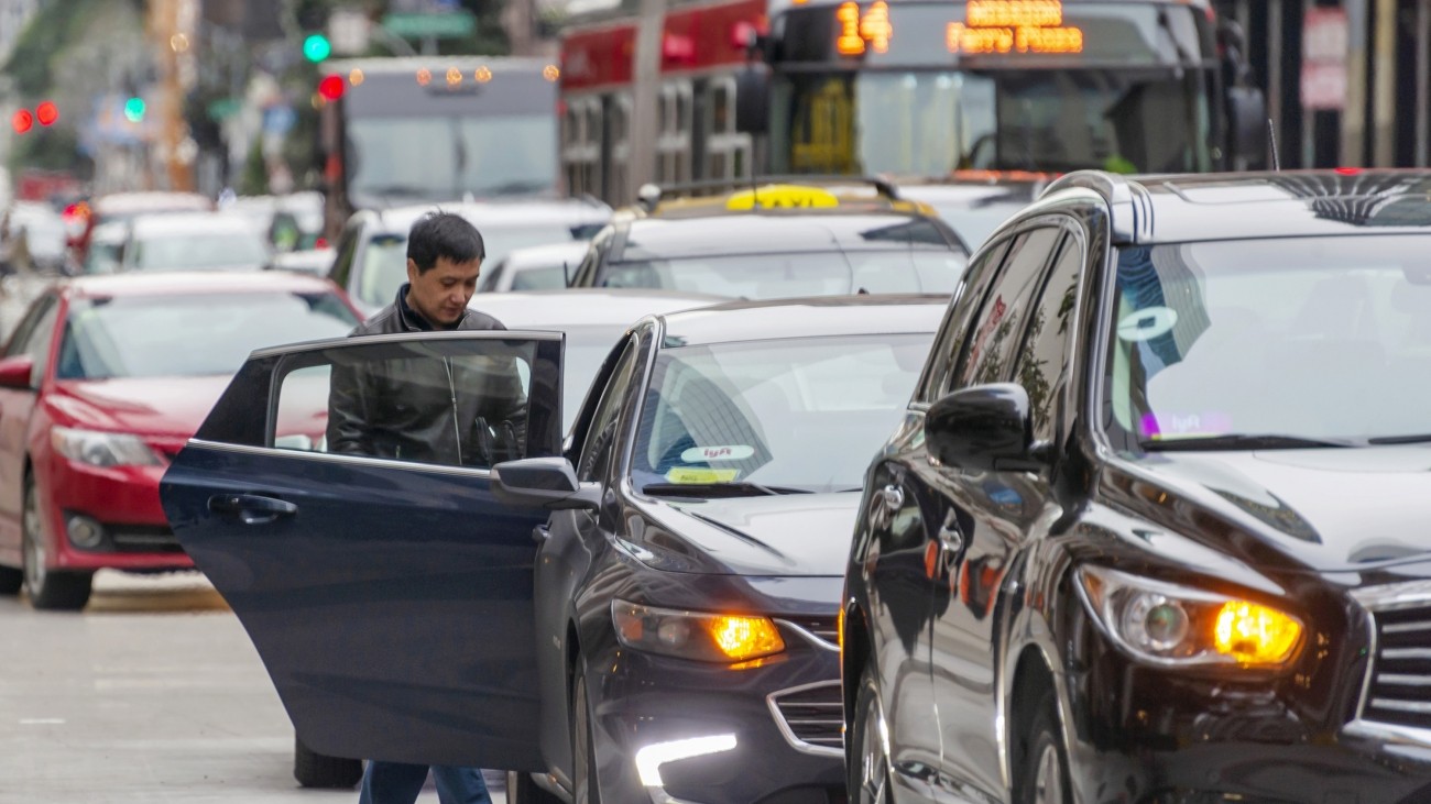 A man entering a Lyft ride-hail vehicle. Photo credit: Sergio Ruiz