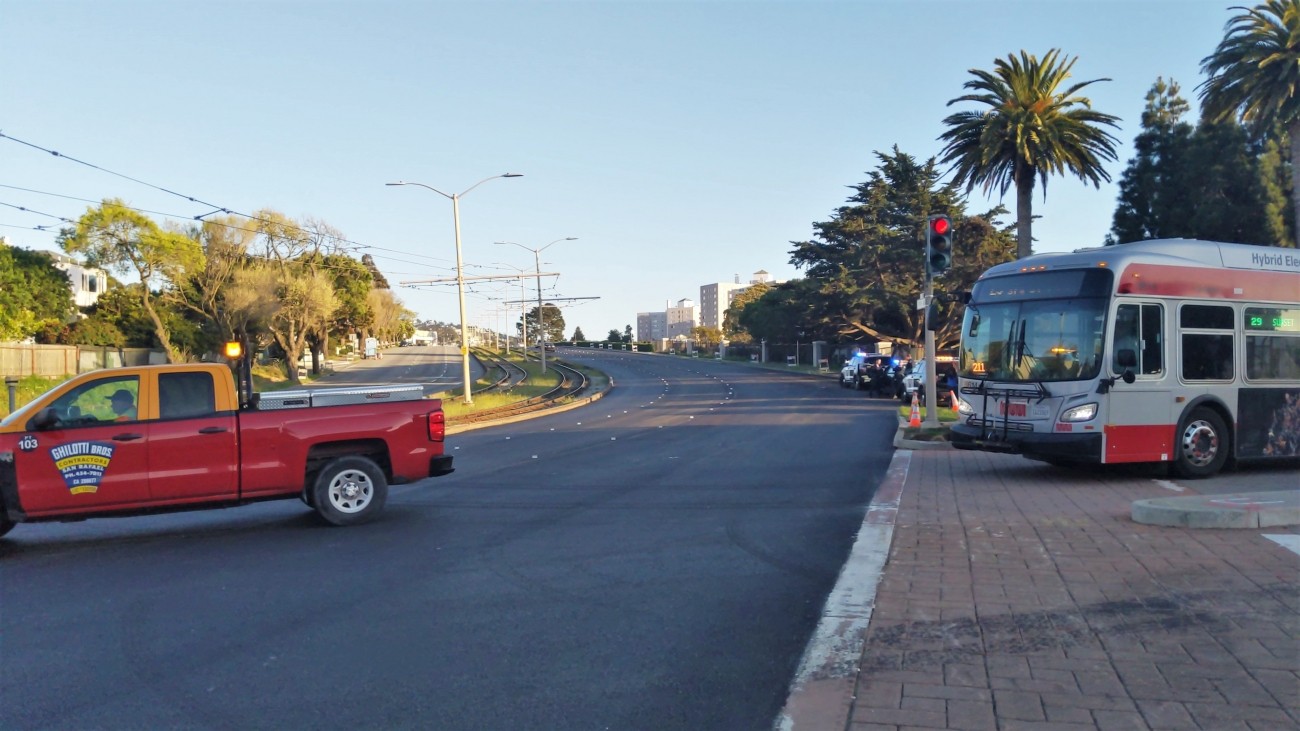 A car and bus driving on the new repaved street