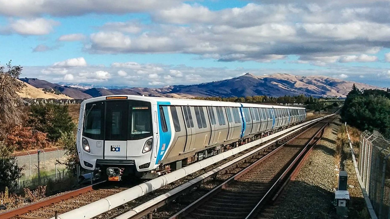 New bart train pulling in to a station