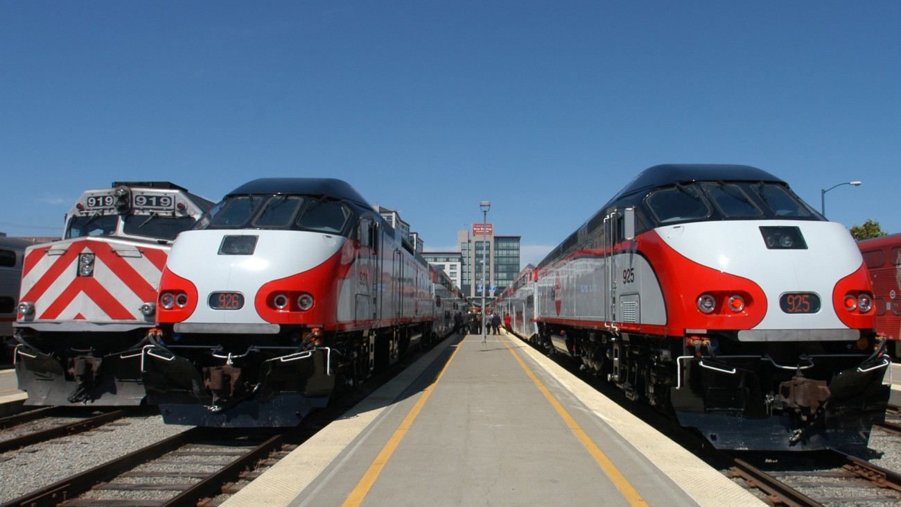 two caltrain trains waiting at the platform