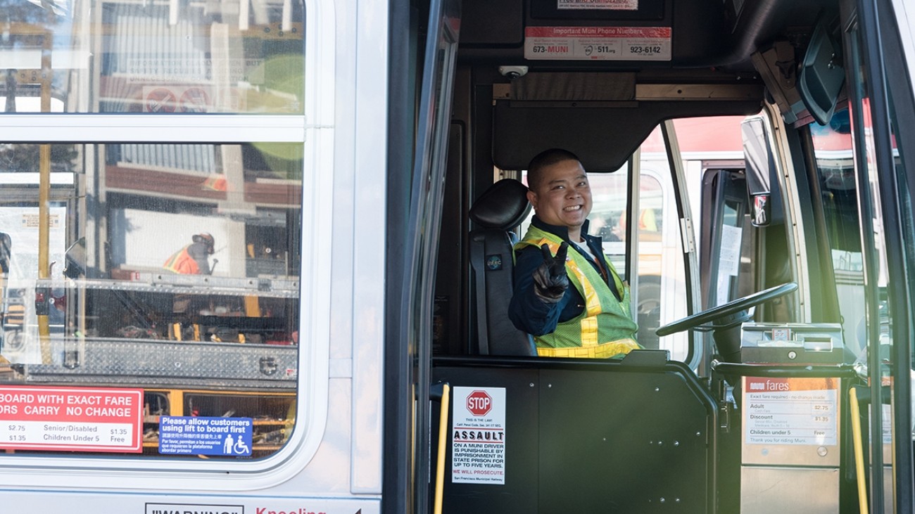 SFMTA Muni bus driver holding up peace sign