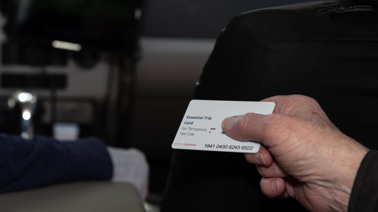 Essential trip card being handed to driver