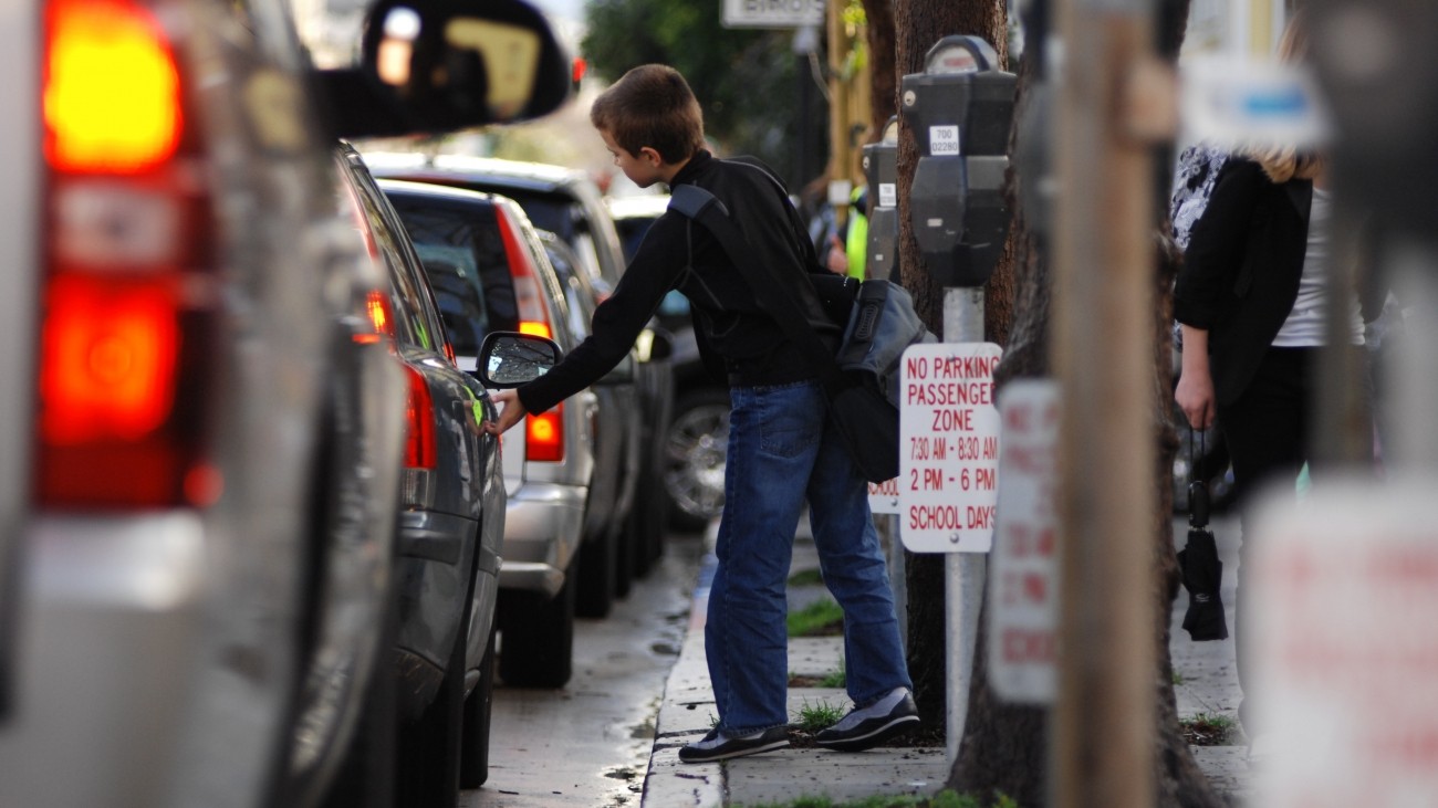 Photo of student getting into parent's car at school