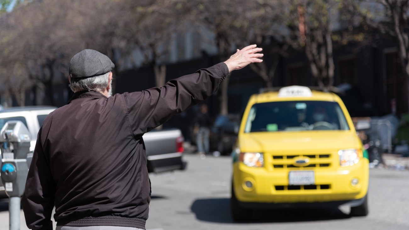 Person hailing a taxi cab