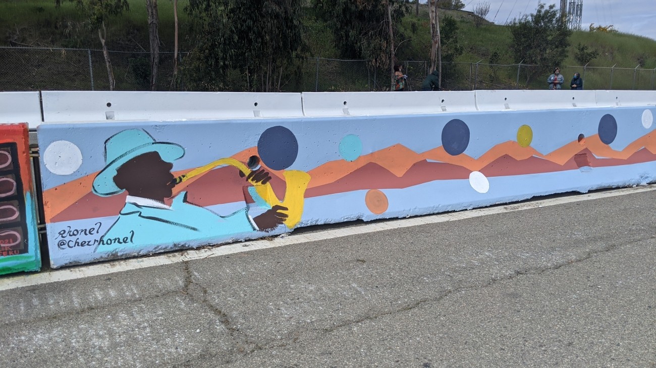 Mural of person playing saxaphone in a blue suit 