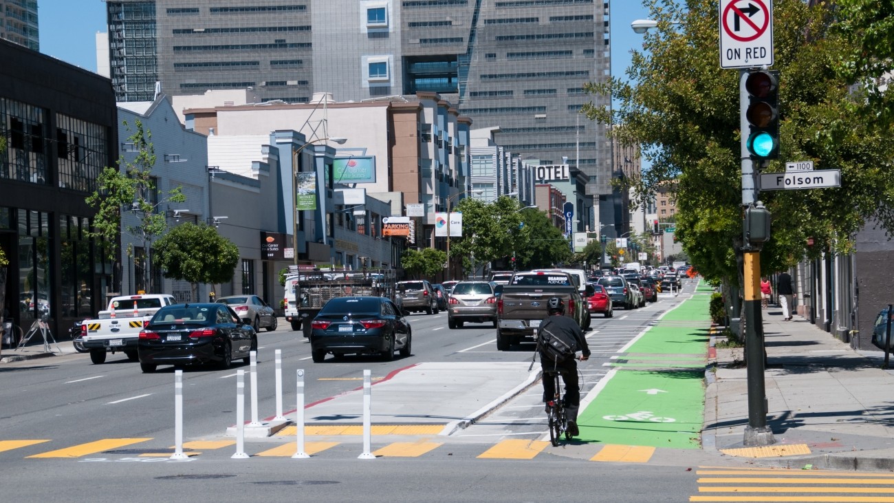 Bicyclist and vehicles by Folsom Street