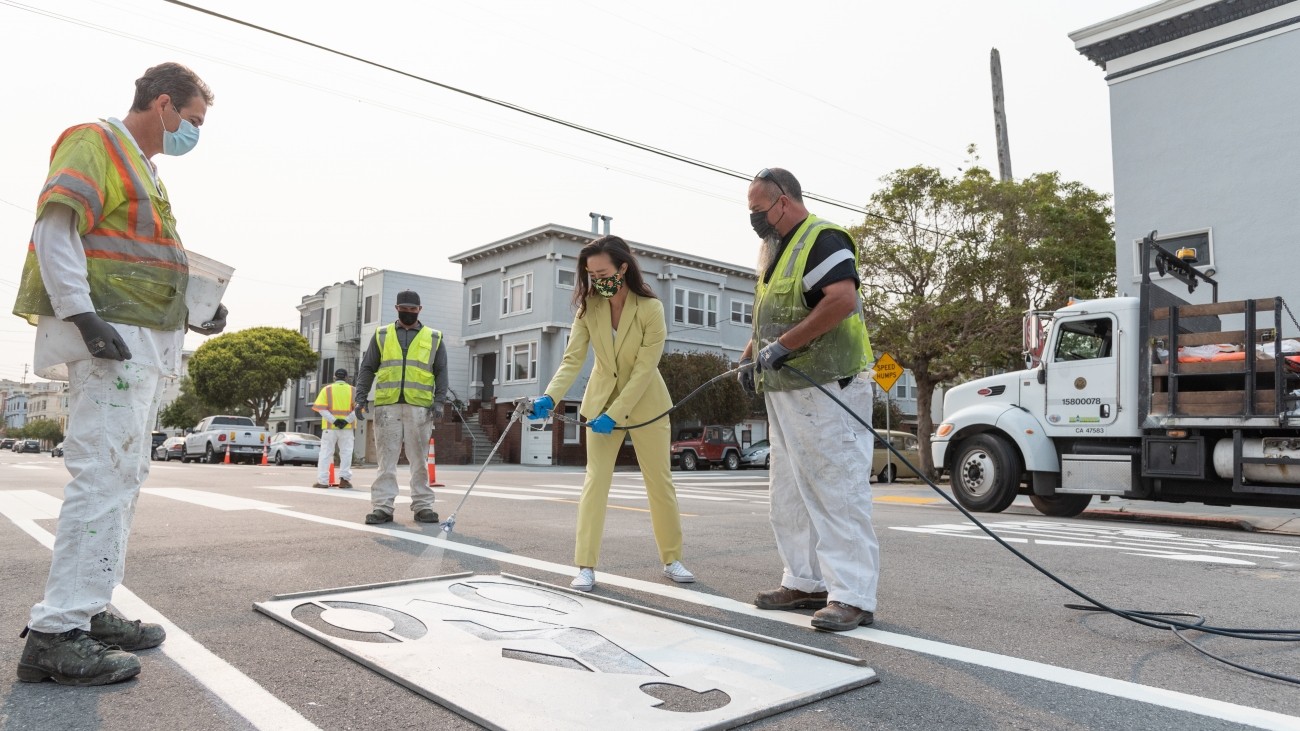 Transportation Authority Board Member Connie Chain and SFMTA staff adding bike lane indication on Anza Street