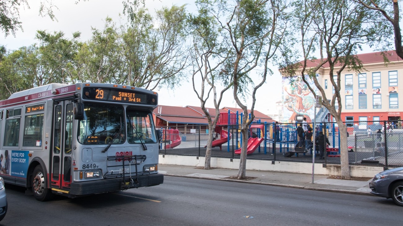 Muni bus driving past school yard