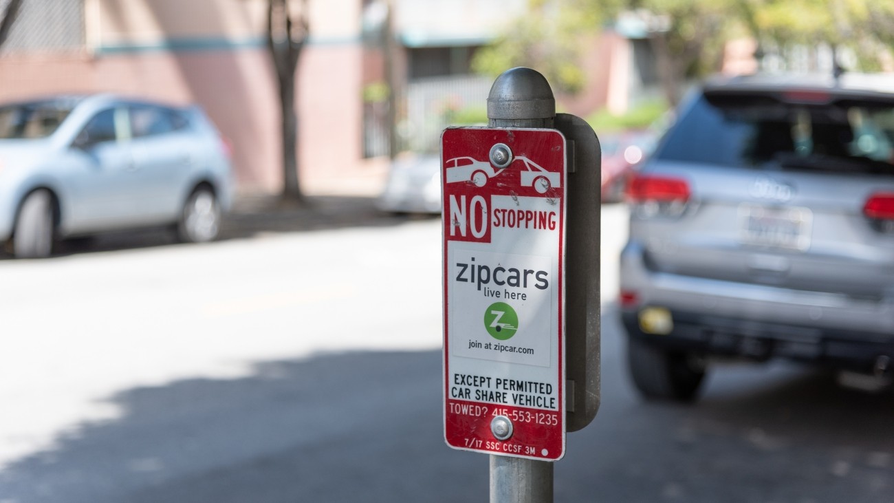 A sign near the curb says "no stopping except permitted car share vehicles." Photo by SFMTA Photography Department