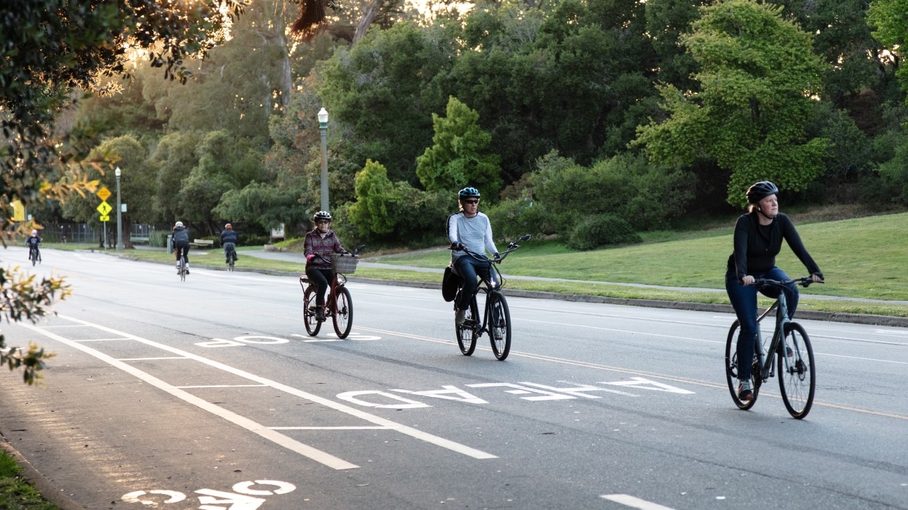 People biking on a street in Golden Gate Park.