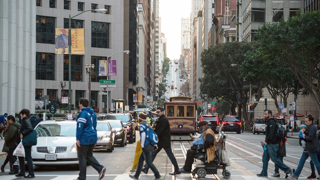 Pedestrians and wheelchair user crossing street in San Francisco