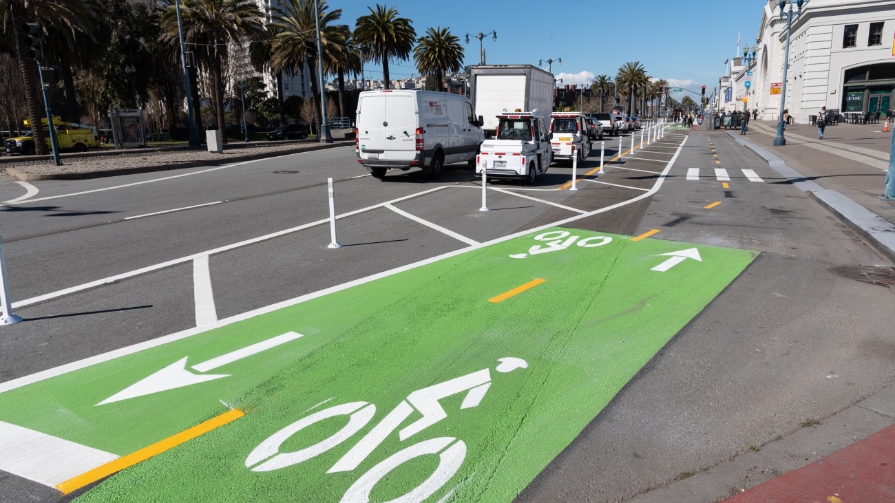 Bike lane with green paint and depictions of bike rider on road