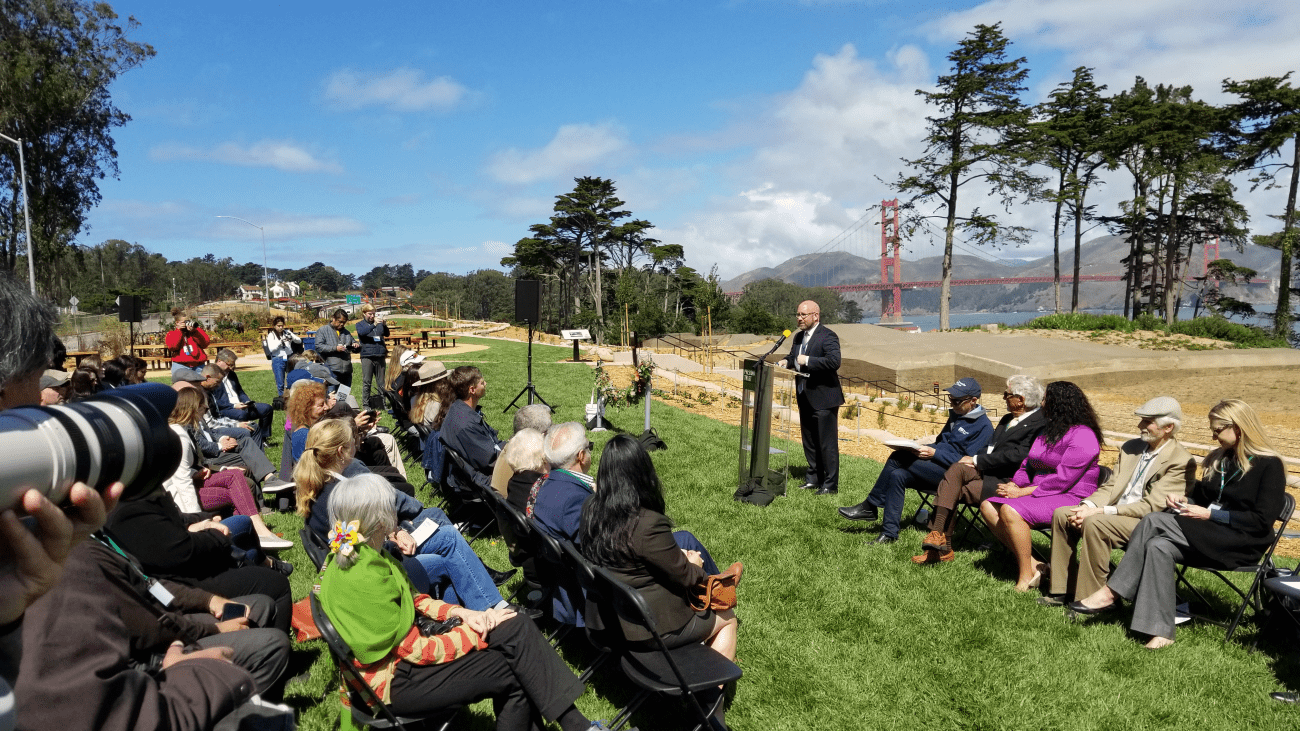 Transportation Authority Board Chair Rafael Mandelman speaking to crowd in the Presidio