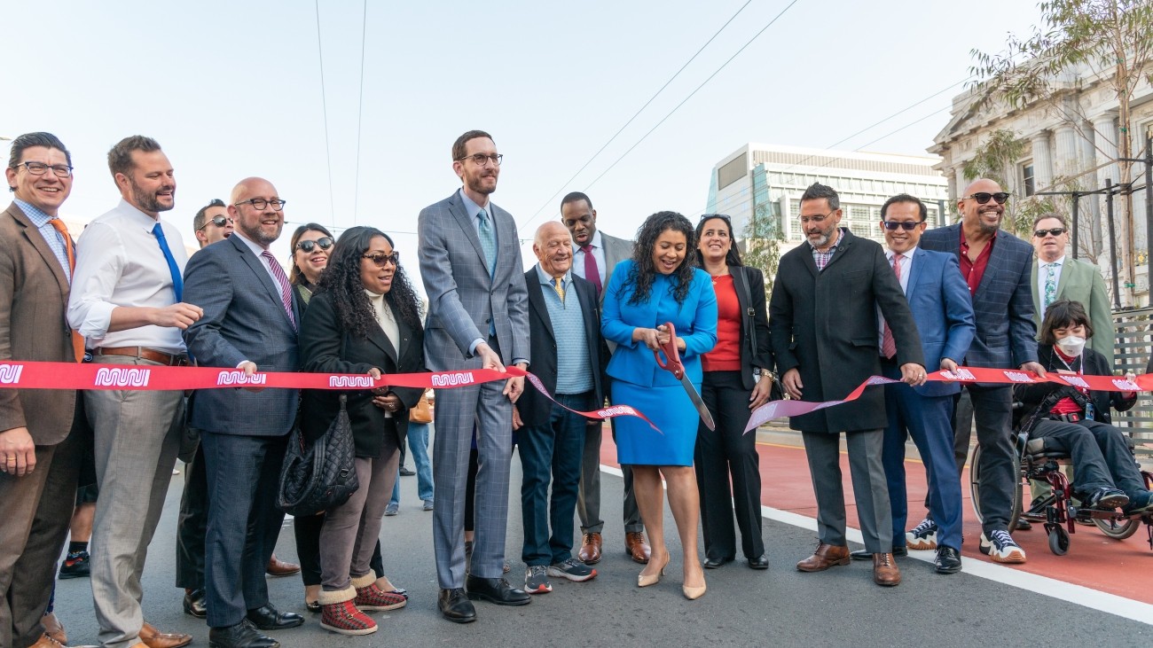 People cutting ribbon for celebration