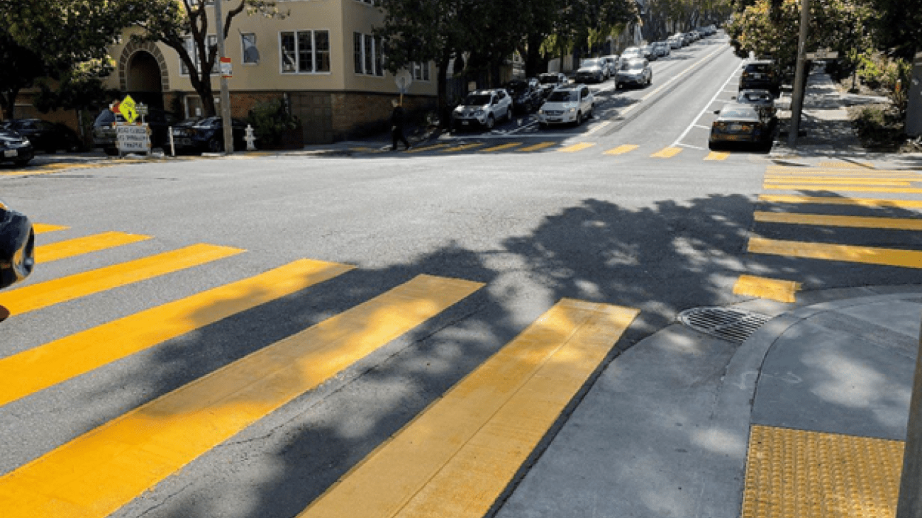 Bright yellow crosswalks and truncated dome bump pads at 14th Street and Noe Street