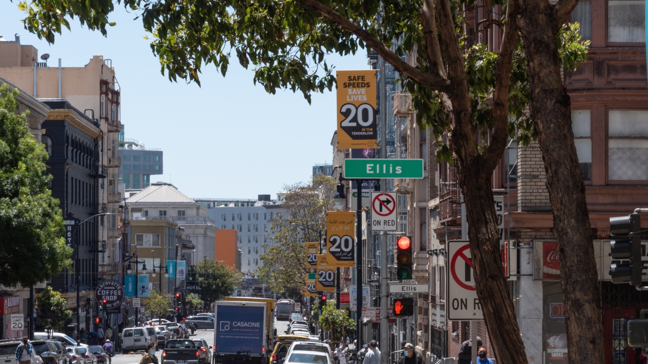 Ellis Street with Vision Zero signage and people on the sidewalk and cars on the road