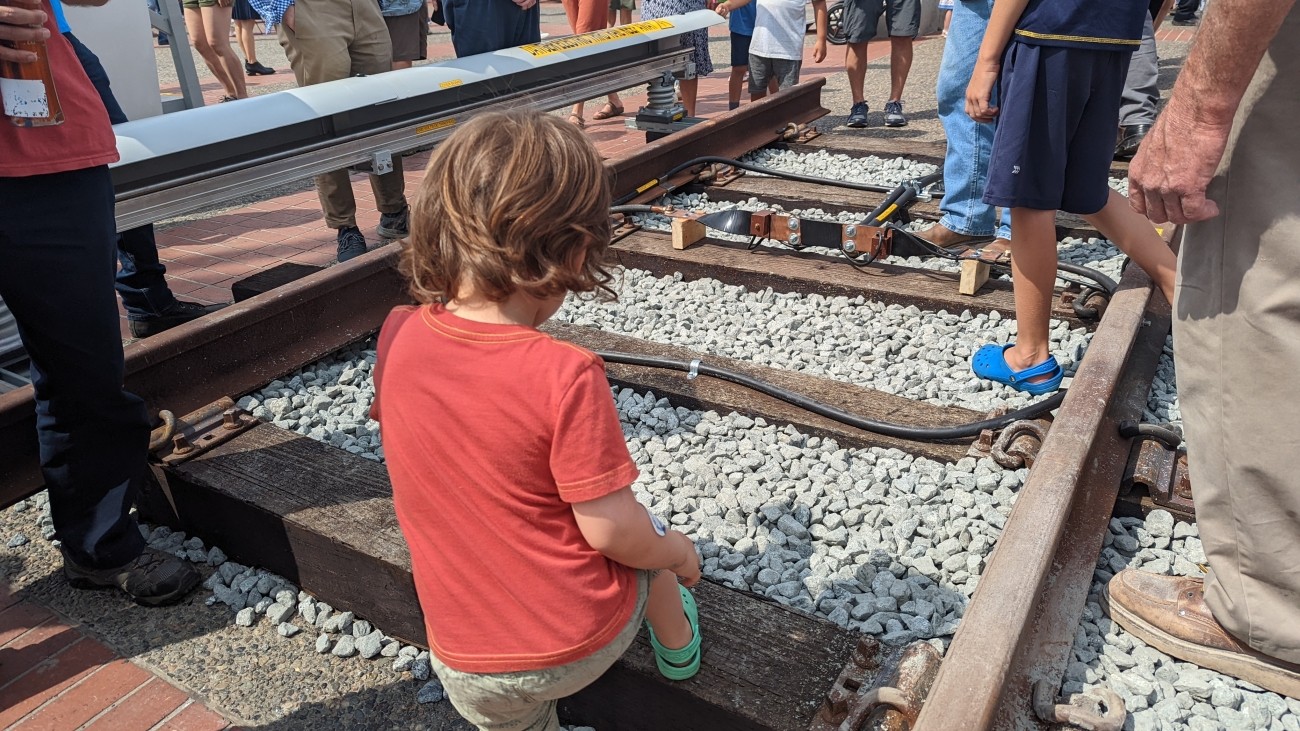 Child walking on BART tracks. 