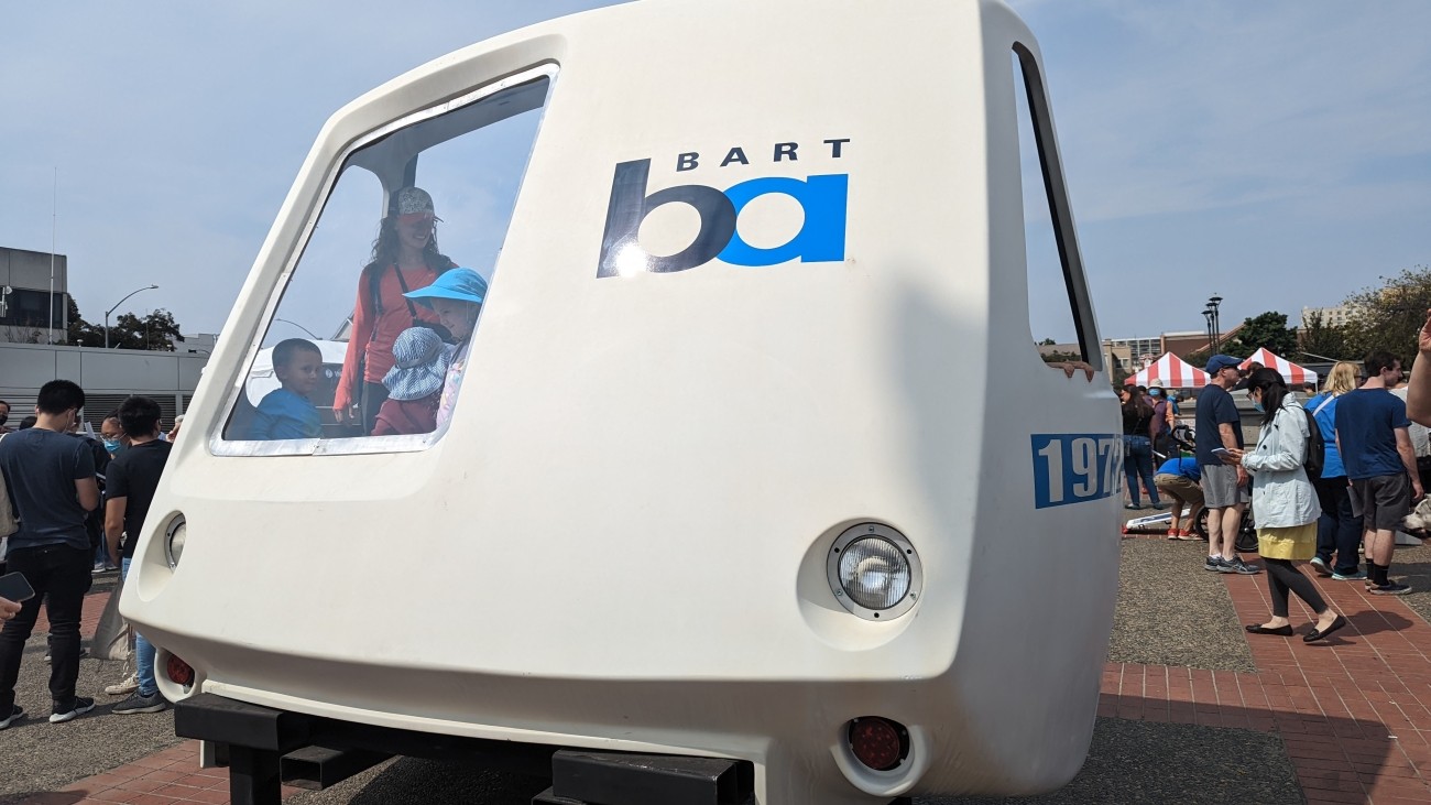 Visitors inside looking through window of first BART train