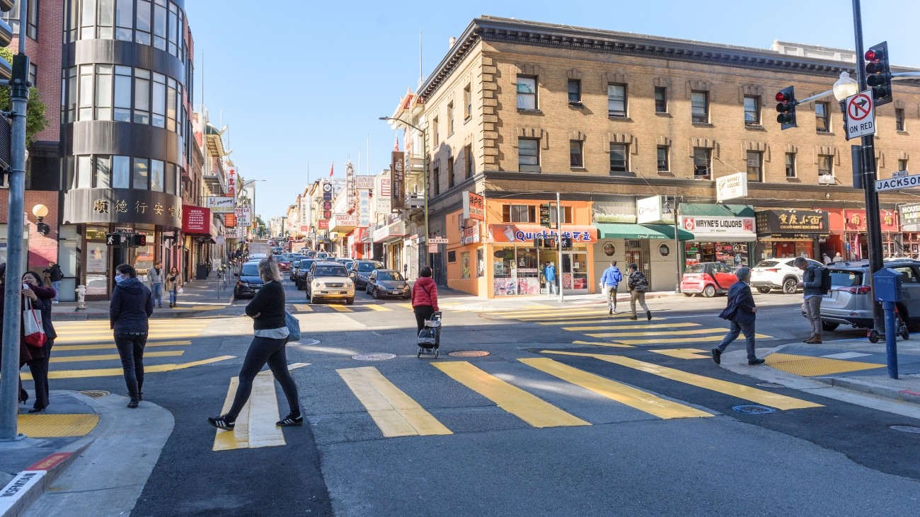 Pedestrians crossing in pedestrian scramble in Chinatown at Kearny and Jackson Streets